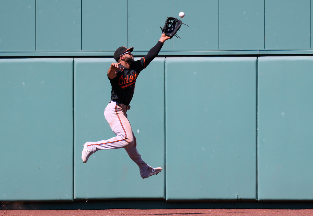 Baltimore Orioles right fielder Colton Cowser leaps but can't make the play on a double by Boston Red Sox's Andruw Monasterio during the fifth inning of a baseball game, Thursday, June 4, 2026, in Boston. (AP Photo/Charles Krupa)