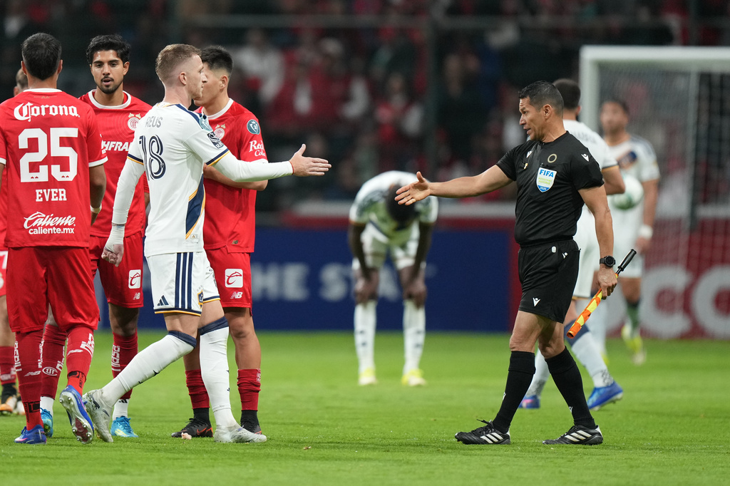 Marco Reus of the United States' LA Galaxy, left, shakes hands with a referee at the end of a CONCACAF Champions Cup quarterfinal first leg soccer match in Toluca, Mexico, Wednesday, April 8, 2026. (AP Photo/Fernando Llano)