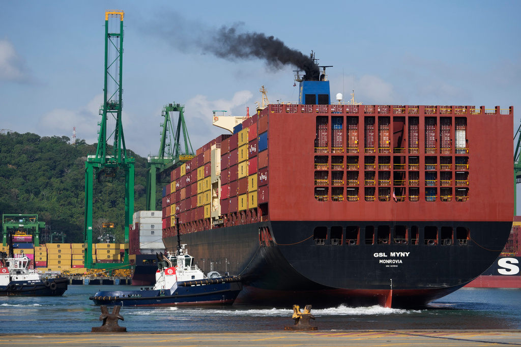 A cargo ship is guided by a tugboat through the Panama Canal in Panama City, Thursday, April 9, 2026. (AP Photo/Matias Delacroix)