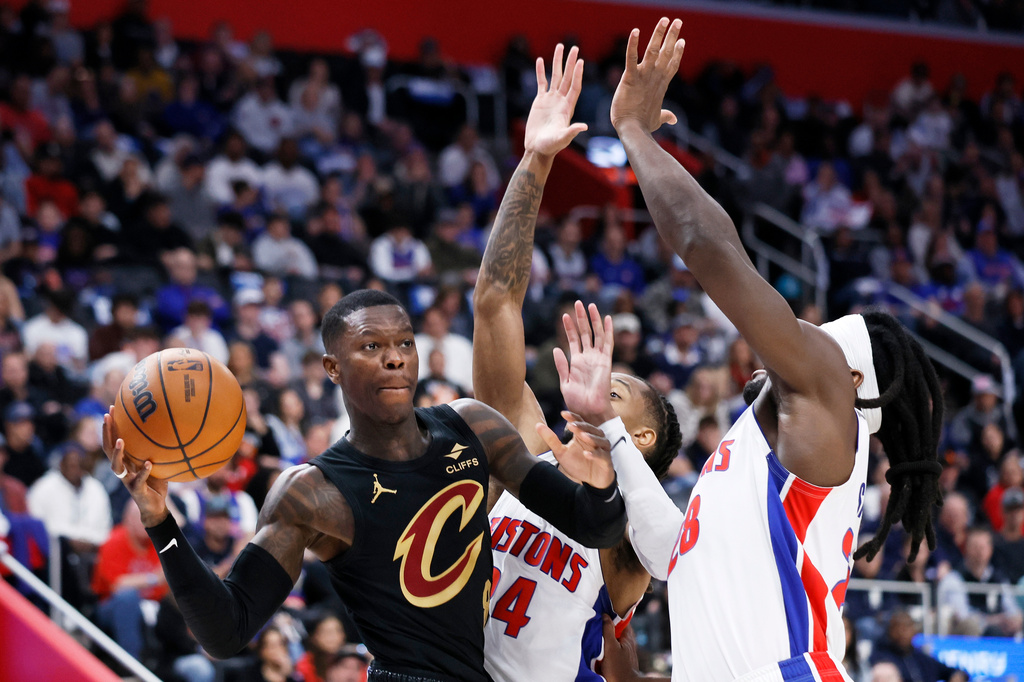 Cleveland Cavaliers guard Dennis Schroder, left, passes the ball against Detroit Pistons guard Daniss Jenkins (24) and forward Isaiah Stewart (28) during the first half in Game 2 of a second-round NBA playoffs basketball series, Thursday, May 7, 2026, in Detroit. (AP Photo/Duane Burleson)