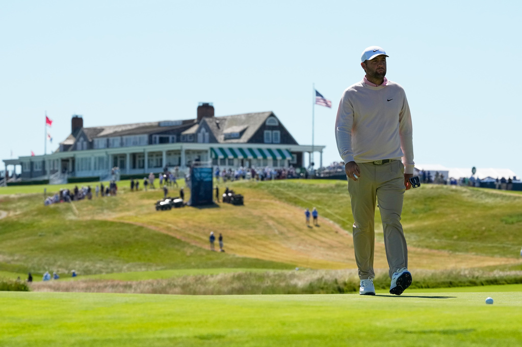 Scottie Scheffler walks to green on the first hole during a practice round for the U.S. Open golf tournament at Shinnecock Hills Golf Club in Southampton, N.Y., Tuesday, June 16, 2026.(AP Photo/David J. Phillip)