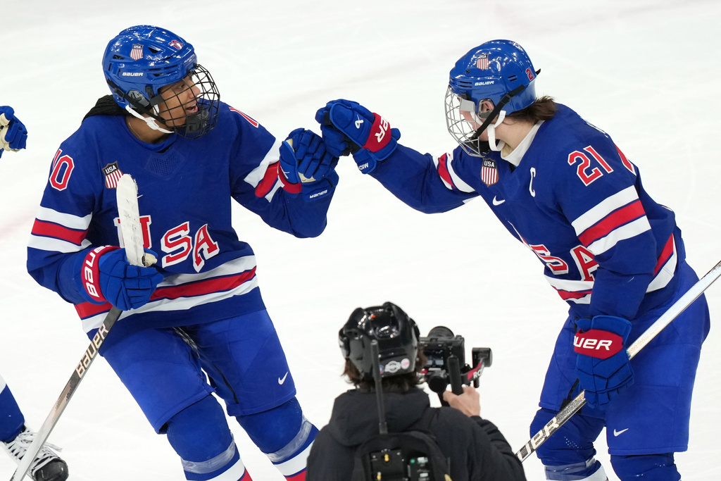 United States' Hilary Knight (21) celebrates with Laila Edwards (10) after Knight deflected a shot by Edwards for a goal against Canada during the third period of the women's ice hockey gold medal game at the 2026 Winter Olympics, in Milan, Italy, Thursday, Feb. 19, 2026. (AP Photo/Carolyn Kaster)