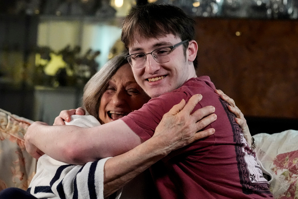 Donna West and her grandson Paul Quirk embrace during an interview, Tuesday, Dec. 2, 2025, in Marietta, Ga. (AP Photo/Mike Stewart)