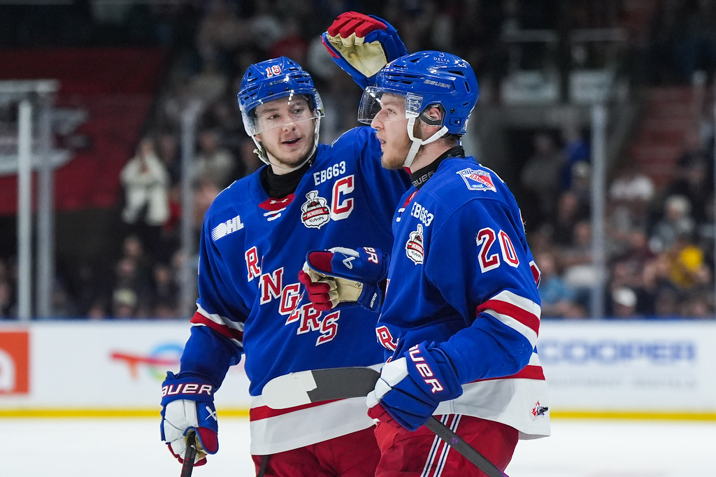 Kitchener Rangers' Cameron Reid (18) and Gabriel Chiarot (20) celebrate after Chiarot's goal during the second period of a Memorial Cup hockey game against the Everett Silvertips in Kelowna, British Columbia, Monday, May 25, 2026. (Darryl Dyck/The Canadian Press via AP)