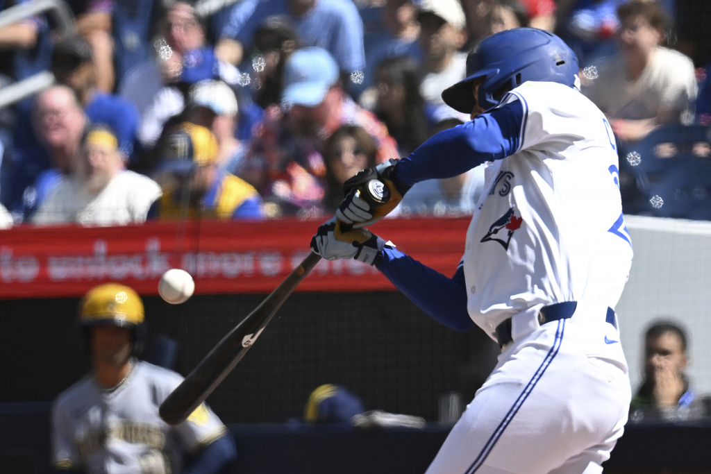 Toronto Blue Jays' Ernie Clement (22) hits an RBI single during the first inning of a baseball game against the Milwaukee Brewers in Toronto on Sunday, Aug. 31, 2025. (Jon Blacker/The Canadian Press via AP)