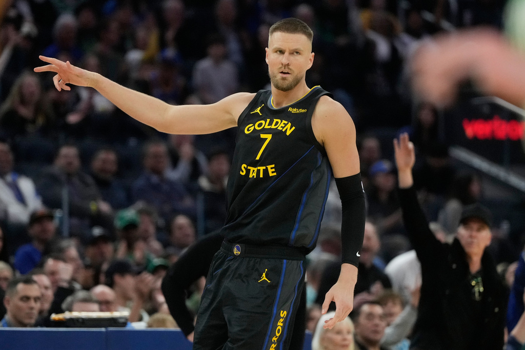 Golden State Warriors center Kristaps Porziņģis (7) gestures after making a 3-point basket during the first half of an NBA basketball game against the Boston Celtics in San Francisco, Thursday, Feb. 19, 2026. (AP Photo/Jeff Chiu)