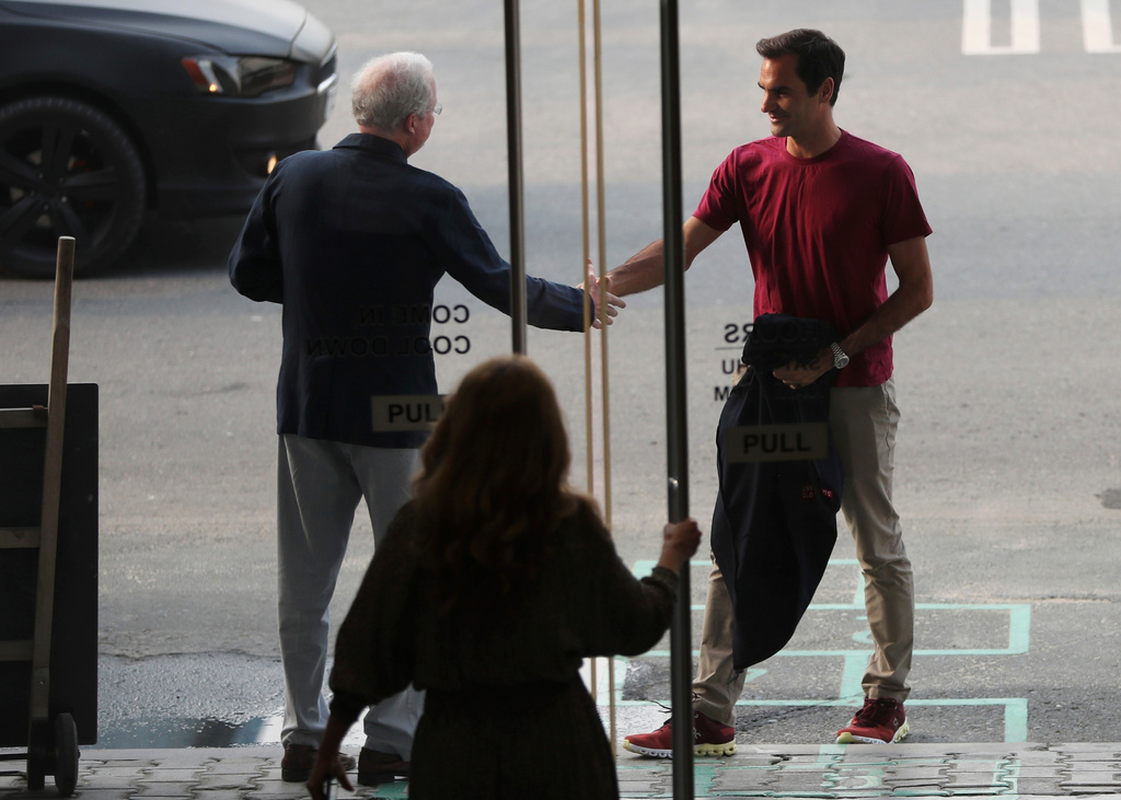 FILE - In this Sunday, Dec. 15, 2019 photo, Roger Federer, right, shakes hands with the Associated Press reporter Howard Fendrich upon his arrival for an exclusive interview in Dubai, United Arab Emirates. (AP Photo/Kamran Jebreili, File)