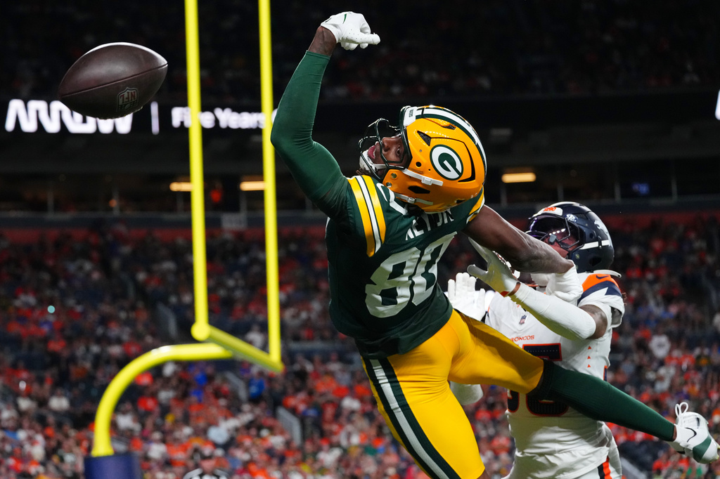 Green Bay Packers wide receiver Isaiah Neyor (80) misses a catch attempt against Denver Broncos cornerback Reese Taylor (35) during the second half of an NFL preseason football game Friday, Aug. 21, 2026, in Denver. (AP Photo/Jack Dempsey)