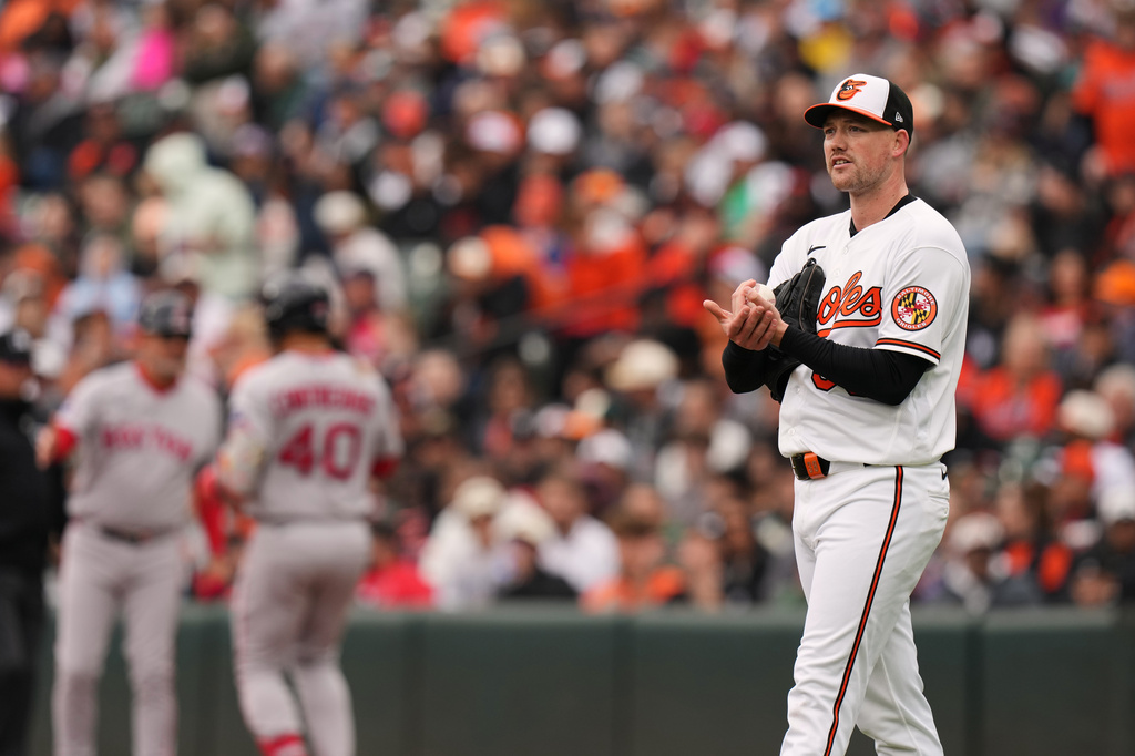 Baltimore Orioles starting pitcher Kyle Bradish reacts after giving up a walk to Boston Red Sox's Willson Contreras during the third inning of a baseball game, Sunday, April 26, 2026, in Baltimore. (AP Photo/Stephanie Scarbrough)