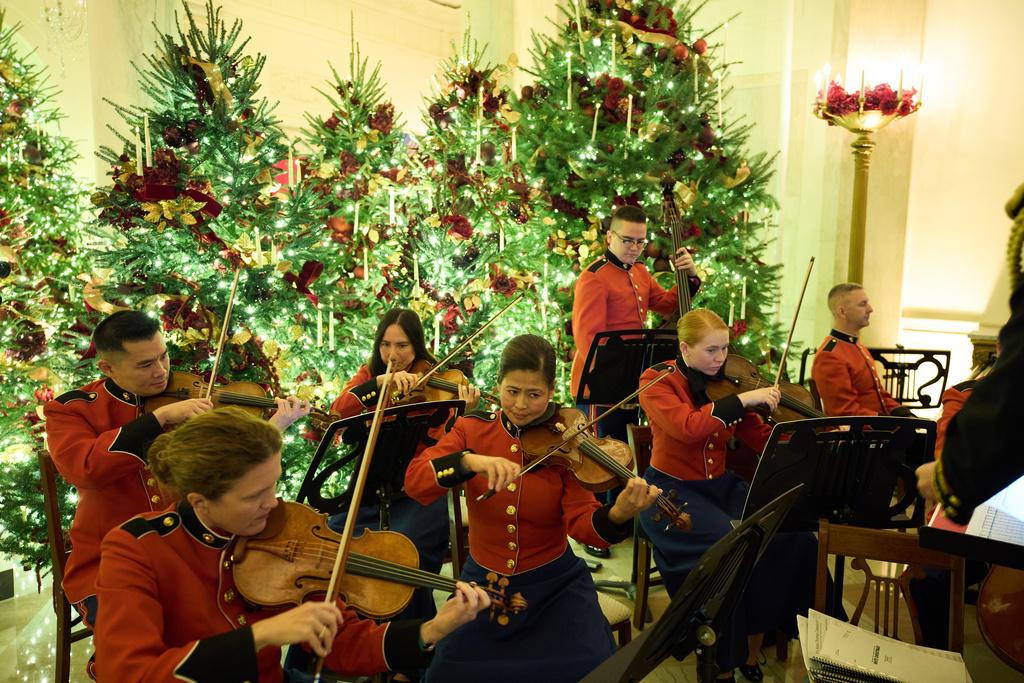 "The President's Own" Marine Band plays in the Grand Foyer of the White House during a press preview of the Christmas decorations "Home is Where the Heart Is," Monday, Dec. 1, 2025, in Washington. (AP Photo/Evan Vucci)