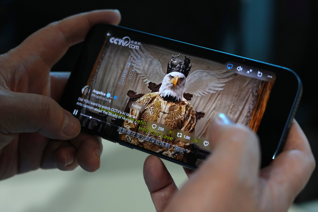 An AI-made viral animation released by Chinese state media mocking the United States as a white eagle is seen on a mobile phone in Beijing, China, Monday, April 6, 2026. (AP Photo/Ng Han Guan)