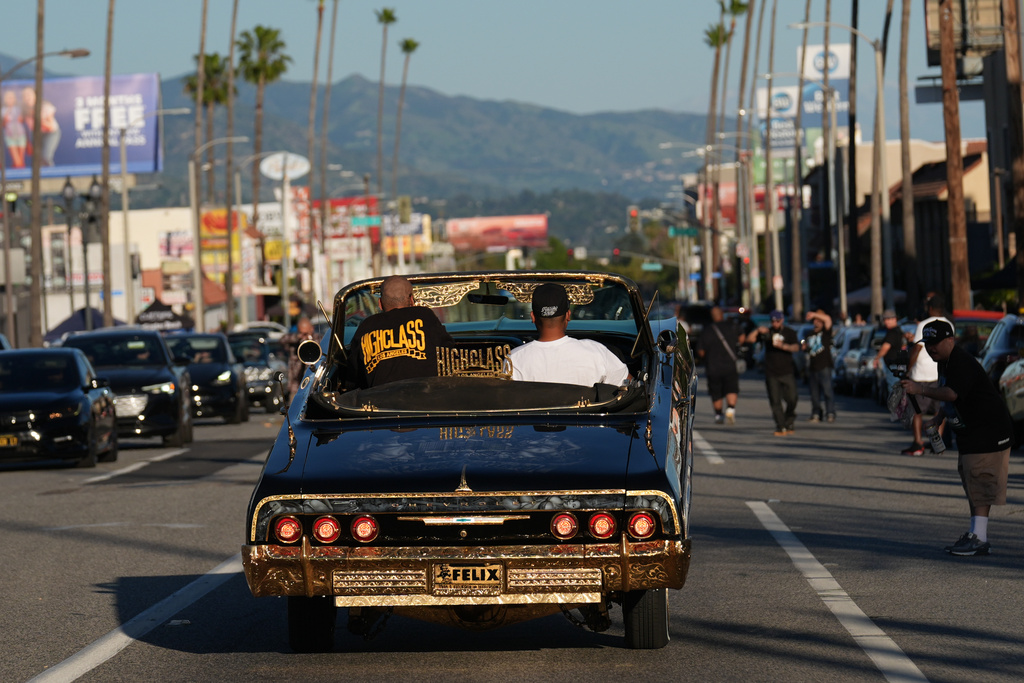 Lowriders cruise at the 6th Annual Lady Lowrider Cruise Night in celebration of International Women's Day in Pasadena, Calif., on Sunday, March 8, 2026. (AP Photo/Damian Dovarganes)