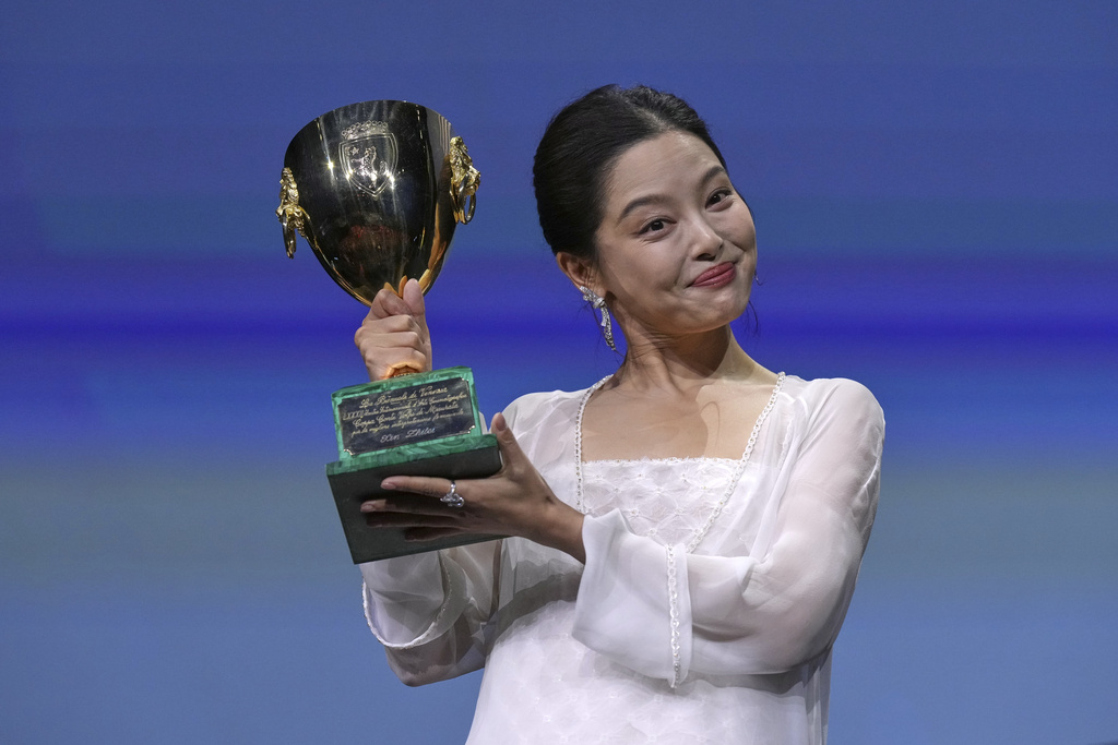 Xin Zhilei accepts the Coppa Volpi award for best actress for 'The Sun Rises on Us All' during the awards ceremony of the 82nd edition of the Venice Film Festival in Venice, Italy, on Saturday, Sept. 6, 2025. (Photo by Alessandra Tarantino/Invision/AP)