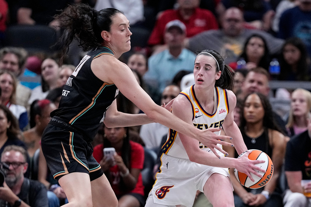 New York Liberty forward Breanna Stewart (30) defends Indiana Fever guard Caitlin Clark (22) in the first half of a WNBA basketball game in Indianapolis, Tuesday, Aug. 11, 2026. (AP Photo/Michael Conroy)