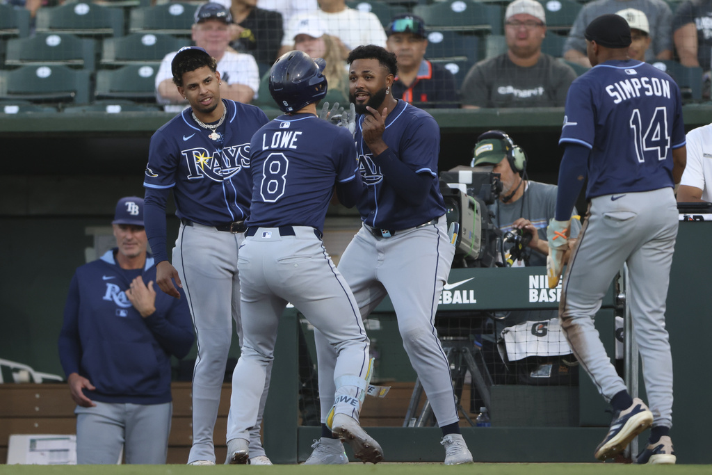 Tampa Bay Rays' Brandon Lowe (8) celebrates with Junior Caminero, center right, after hitting a two run-home run during the second inning of a baseball game against the Athletics, Wednesday, Aug. 13, 2025, in West Sacramento, Calif. (AP Photo/Scott Marshall)