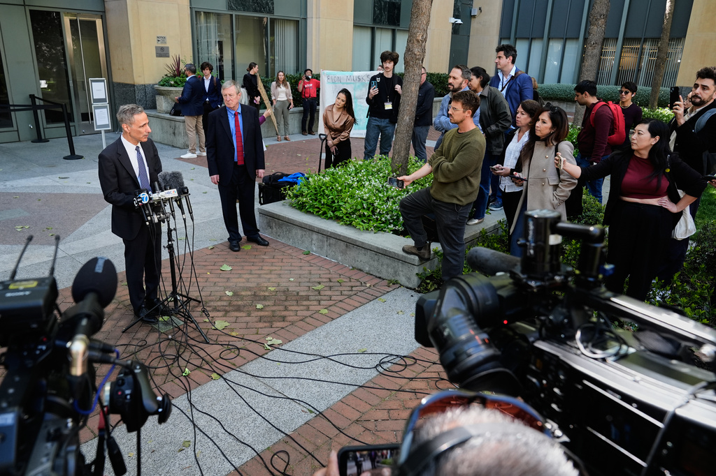 William Savitt, attorney representing OpenAI, left, speaks during a press conference outside the U.S. District Court in Oakland, Calif., Thursday, April 30, 2026. (AP Photo/Godofredo A. Vásquez)