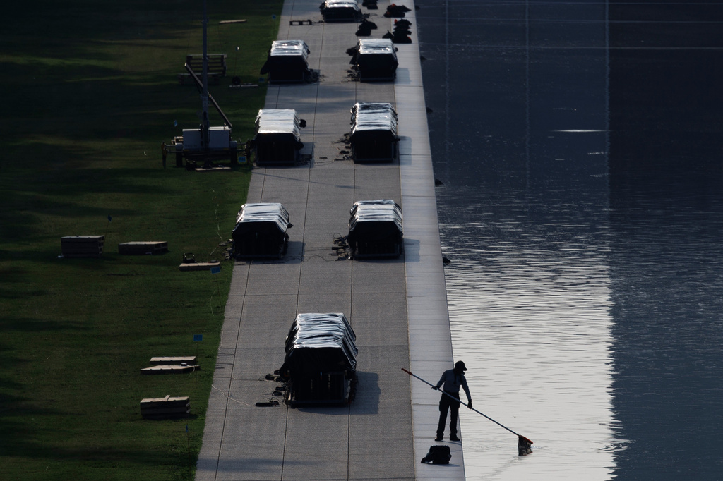 A worker clears debris from the Lincoln Memorial Reflecting Pool, Wednesday, July 1, 2026, in Washington. (AP Photo/Tom Brenner)