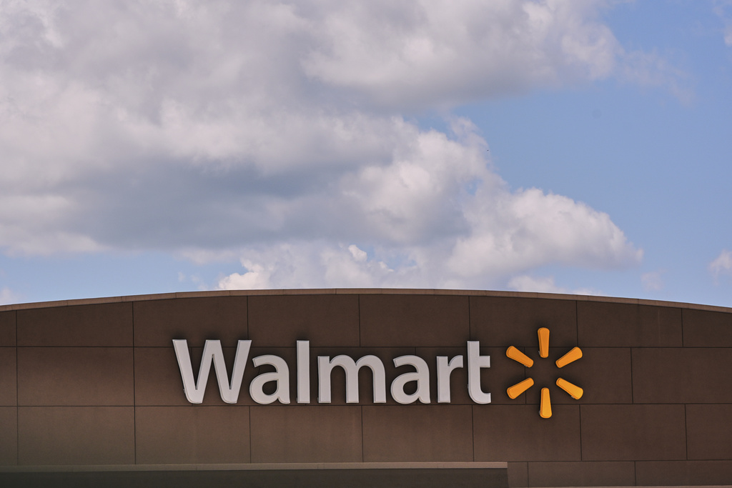 Clouds pass over the Walmart store, Thursday, Aug. 14, 2025, in Manchester, N.H. (AP Photo/Charles Krupa)
