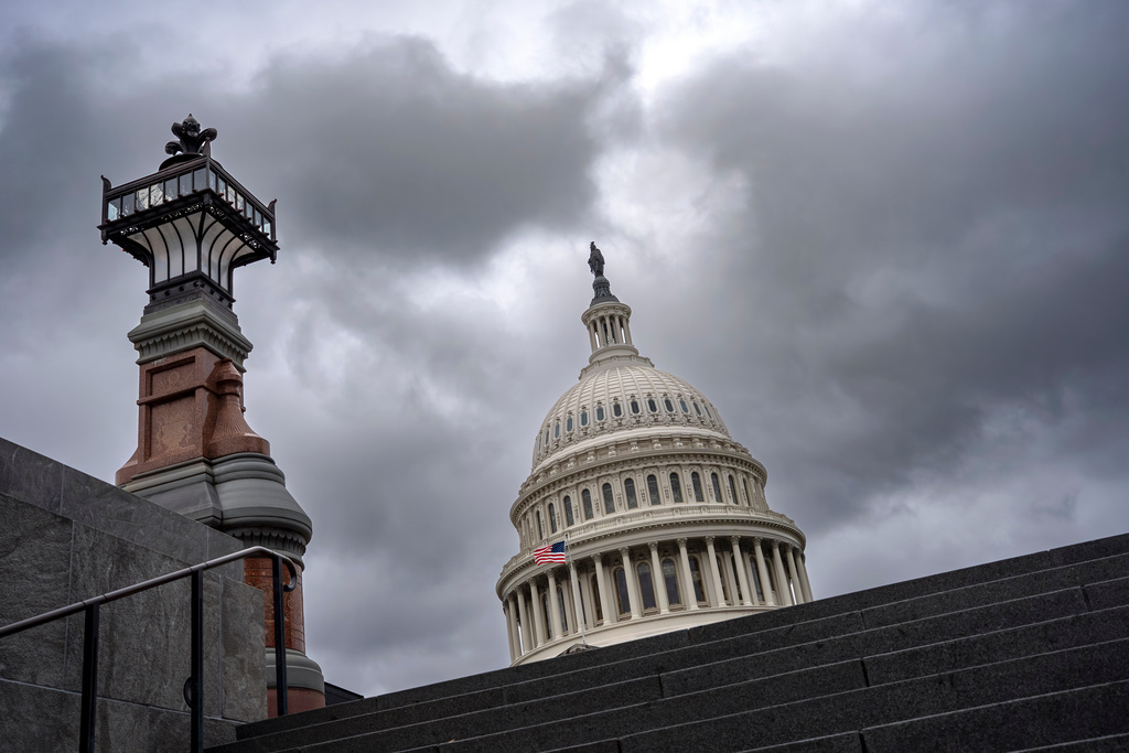 The Capitol is seen under gray skies on the thirteenth day of the government shutdown, in Washington, Monday, Oct. 13, 2025. (AP Photo/J. Scott Applewhite)