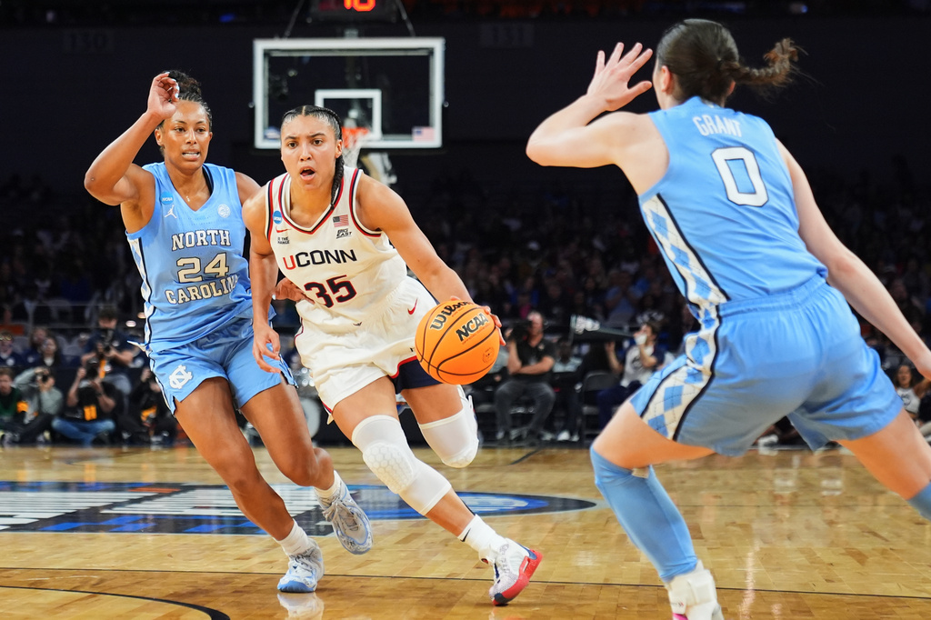 UConn guard Azzi Fudd (35) drives to the basket as North Carolina's Indya Nivar (24) and Lanie Grant (0) defend in the first half in the Sweet 16 of the NCAA college basketball tournament, Friday, March 27, 2026, in Fort Worth, Texas. (AP Photo/Julio Cortez)