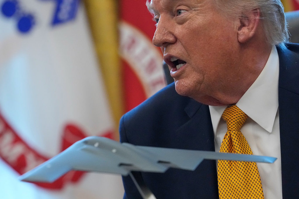 President Donald Trump speaks after signing an executive order regarding a task force on fraud in the Oval Office of the White House, Monday, March 16, 2026, in Washington, with a model of a B-2 stealth bomber in front of him. (AP Photo/Julia Demaree Nikhinson)