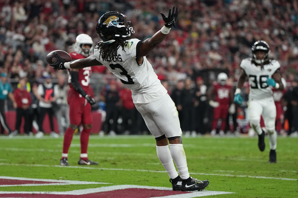 Jacksonville Jaguars wide receiver Jakobi Meyers (3) celebrates after a touchdown during the second half of an NFL football game against the Arizona Cardinals Sunday, Nov. 23, 2025, in Glendale, Ariz. (AP Photo/Rick Scuteri)