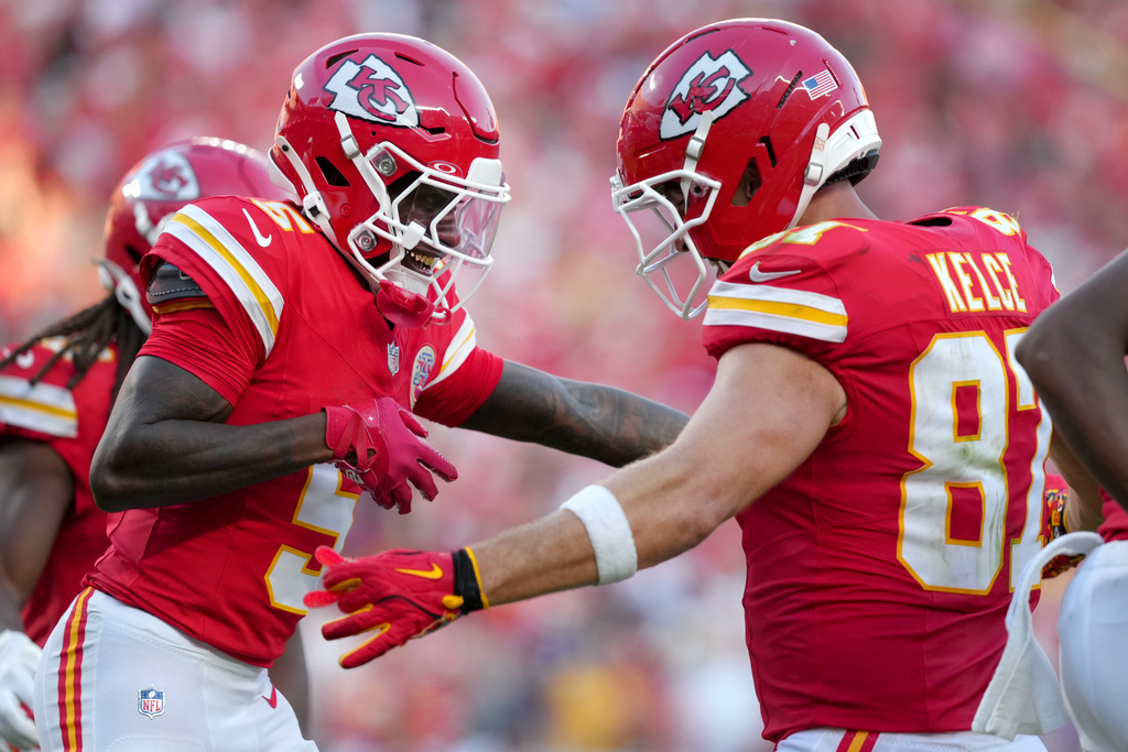 Kansas City Chiefs wide receiver Hollywood Brown, left, is congratulated by tight end Travis Kelce (87) after catching a touchdown pass during the second half of an NFL football game against the Baltimore Ravens Sunday, Sept. 28, 2025, in Kansas City, Mo. (AP Photo/Ed Zurga)