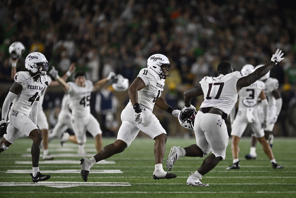 Texas A&M players run onto the field after defeating Notre Dame 41-40 in an NCAA football game Saturday, Sept. 13, 2025, in South Bend, Ind. (AP Photo/Paul Beaty)