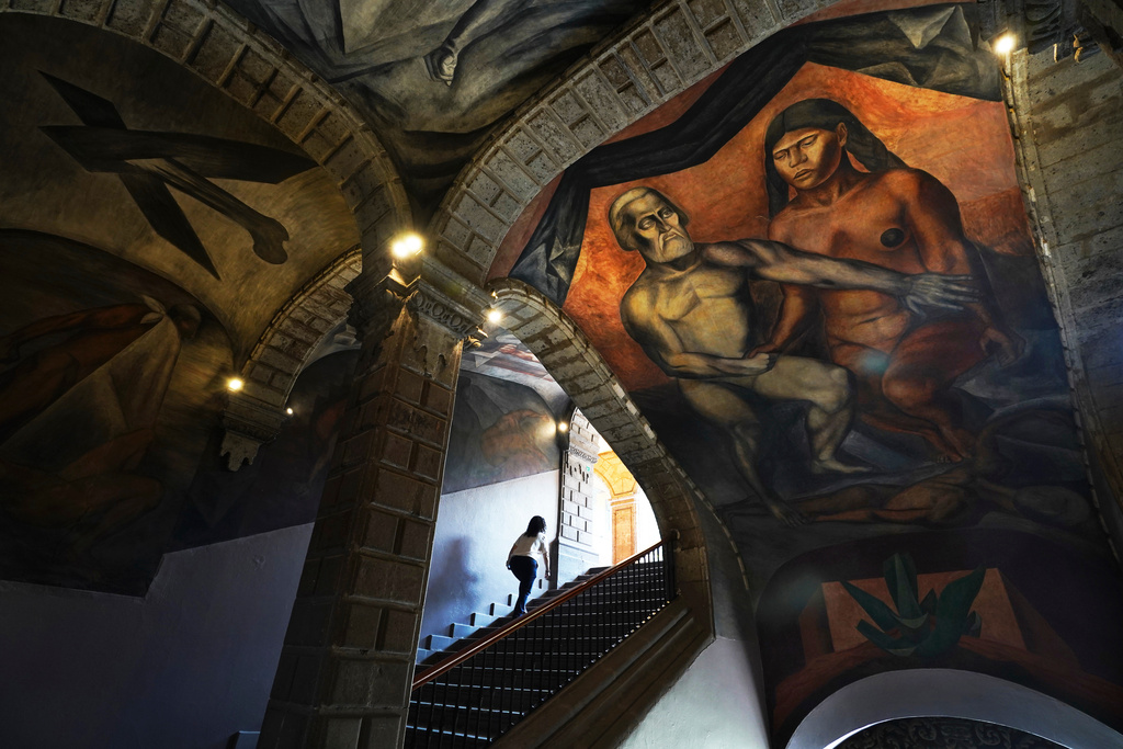 A 1926 fresco of Hernan Cortes and La Malinche by Jose Clemente Orozco decorates the Antiguo Colegio de San Ildefonso in Mexico City, Wednesday, April 26, 2023. (AP Photo/Marco Ugarte)