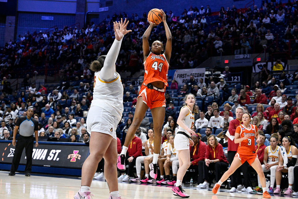 Syracuse center Uche Izoje (44) shoots over Iowa State center Audi Crooks during the first half in the first round of the NCAA college basketball tournament, Saturday, March 21, 2026, in Storrs, Conn. (AP Photo/Jessica Hill)