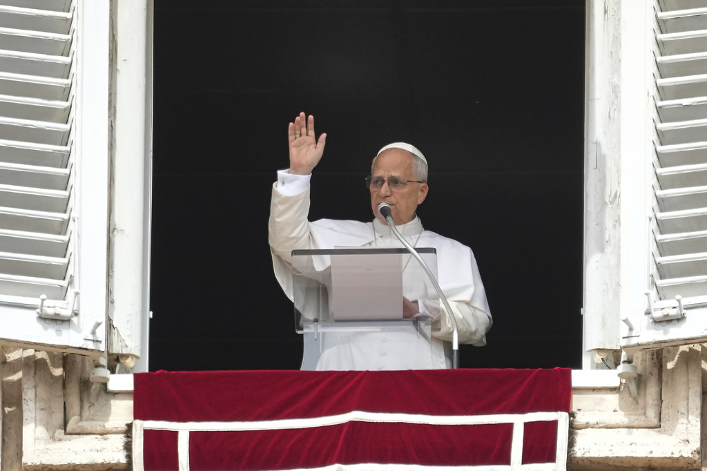 Pope Leo XIV appears at his studio's window to bless the faithful gathered in St. Peter's Square at the Vatican for the Angelus prayer, Sunday, Sept. 14, 2025. (AP Photo/Gregorio Borgia)