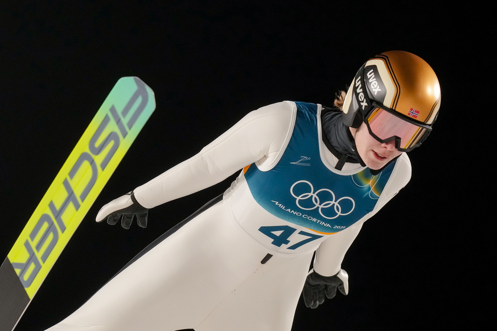 Anna Odine Stroem, of Norway, soars through the air during her first round jump of the ski jumping women's large hill individual at the 2026 Winter Olympics, in Predazzo, Italy, Sunday, Feb. 15, 2026. (AP Photo/Evgeniy Maloletka)