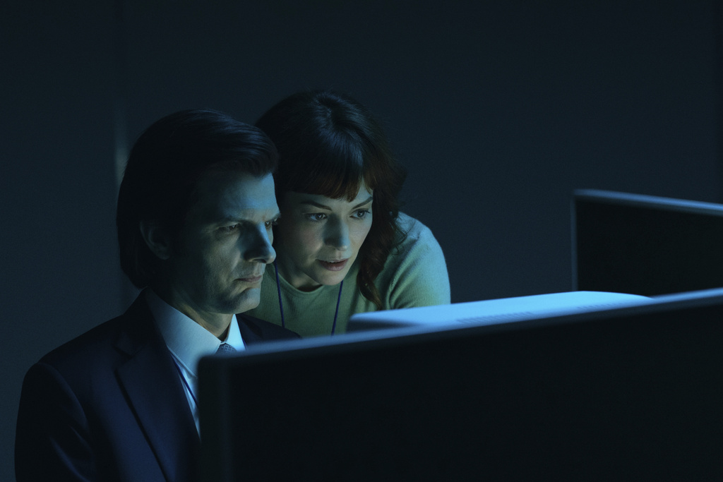 This image released by Apple TV+. shows Adam Scott, left, and Britt Lower in a scene from "Severance." (Apple TV+ via AP)