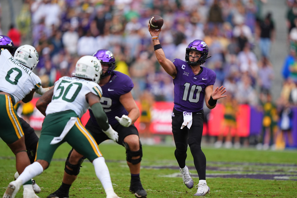 TCU quarterback Josh Hoover (10) throws a pass as Baylor defenders Matthew Fobbs-White (50) and Jackie Marshall (0) are blocked during the first half of an NCAA college football game Saturday, Oct. 18, 2025, in Fort Worth, Texas. (AP Photo/LM Otero)