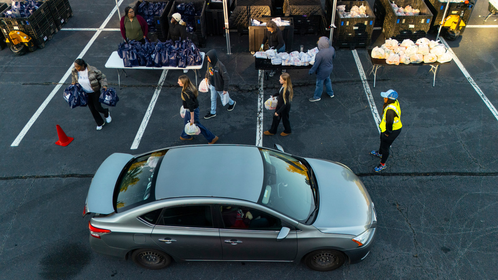 MUST Ministries delivers food to the public via a drive through service, Saturday, Nov. 1, 2025, in Austell, Ga. (AP Photo/Mike Stewart)