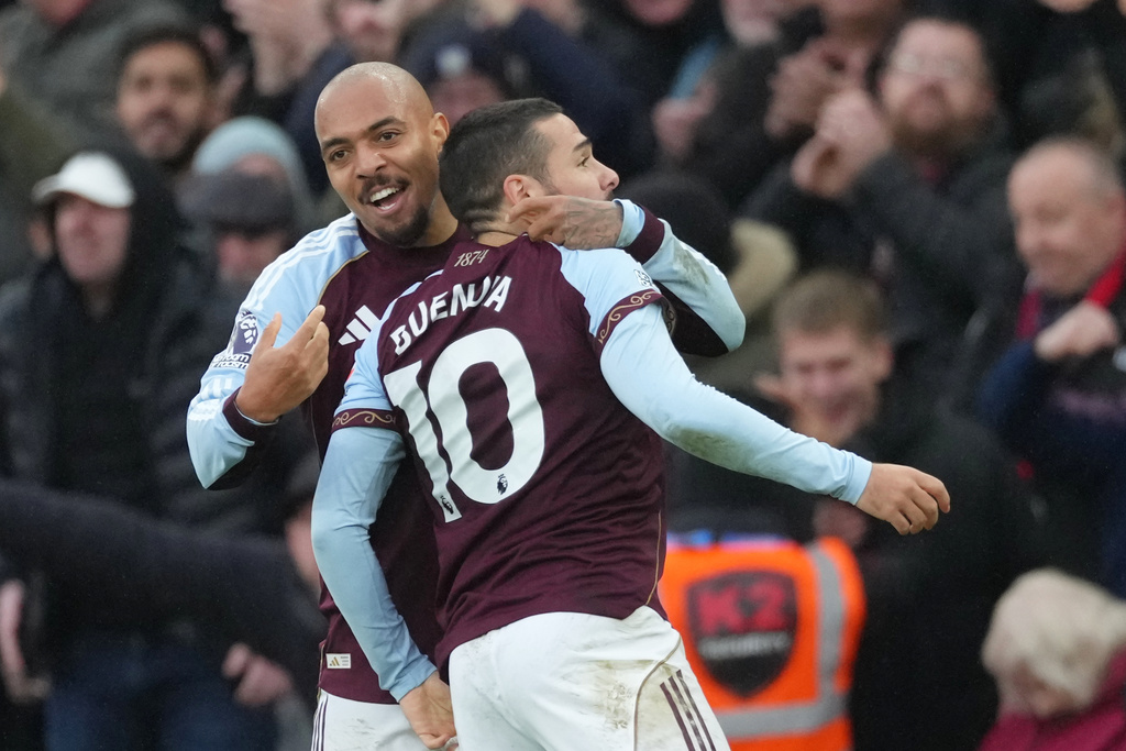 Aston Villa's Emiliano Buendia, right, celebrates with Aston Villa's Donyell Malen after scoring his side's second goal during the English Premier League soccer match between Aston Villa and Arsenal in Birmingham, England, Saturday, Dec. 6, 2025. (AP Photo/Dave Shopland)