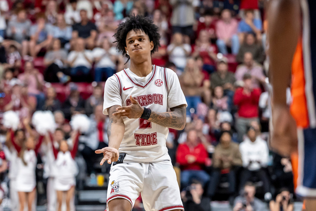 Alabama guard Aden Holloway celebrates after a 3-point basket against Auburn during the second half of an NCAA college basketball game Saturday, March 7, 2026, in Tuscaloosa, Ala. (AP Photo/Vasha Hunt)
