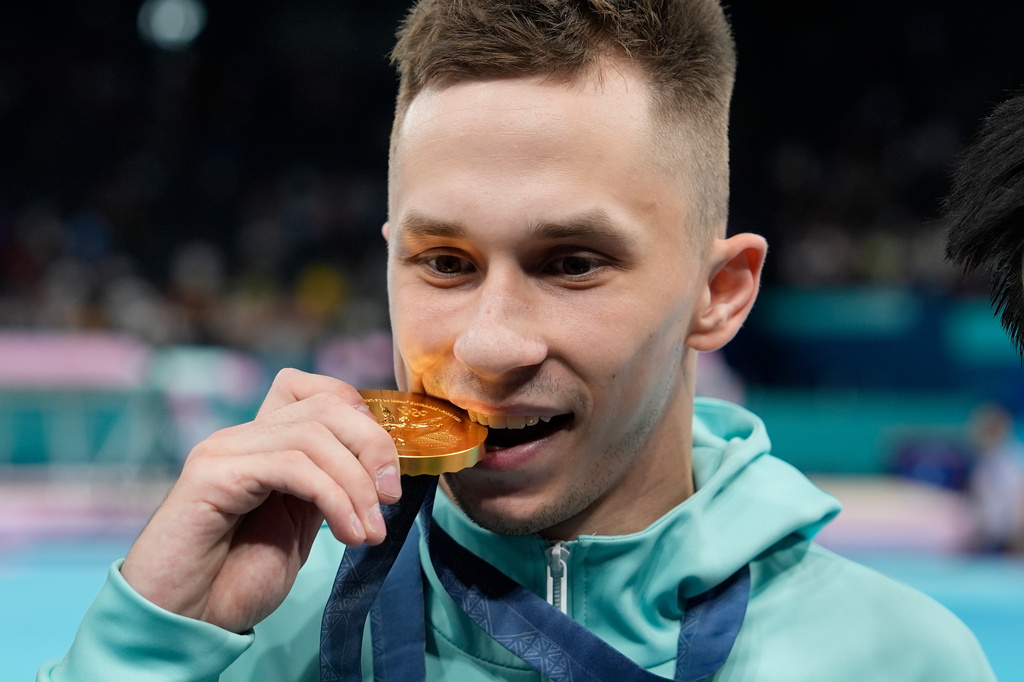 FILE - Ivan Litvinovich of the Individual Neutral Athletes celebrates after winning the gold medal during the men's trampoline finals in Bercy Arena at the 2024 Summer Olympics, Friday, Aug. 2, 2024, in Paris, France. (AP Photo/Charlie Riedel, File)