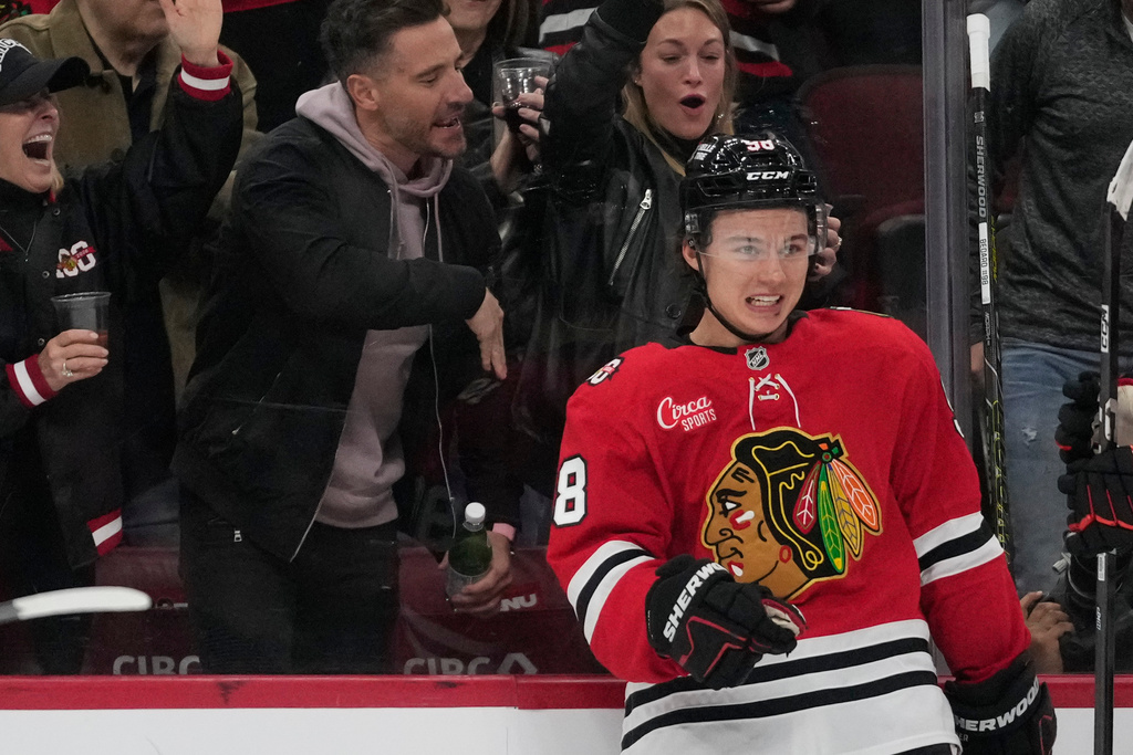 Chicago Blackhawks center Connor Bedard (98) celebrates his hat trick against the Ottawa Senators during the third period of an NHL hockey game Tuesday, Oct. 28, 2025, in Chicago. (AP Photo/Erin Hooley)