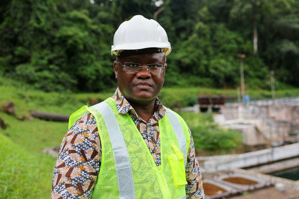 Maada Kpenge, managing director of Guma Valley water company, poses near the water treatment area in Western Area Peninsula National Park, Sierra Leone, Wednesday, July 2, 2025. (AP Photo/Misper Apawu)