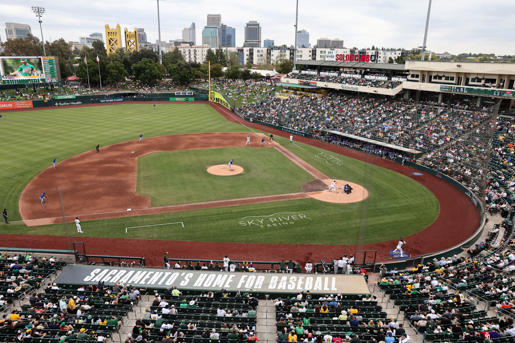 Kansas City Royals pitcher Cole Ragans, center, throws to the Athletics during the fifth inning of a baseball game Sunday, Sept. 28, 2025, in West Sacramento, Calif. (AP Photo/Sara Nevis)
