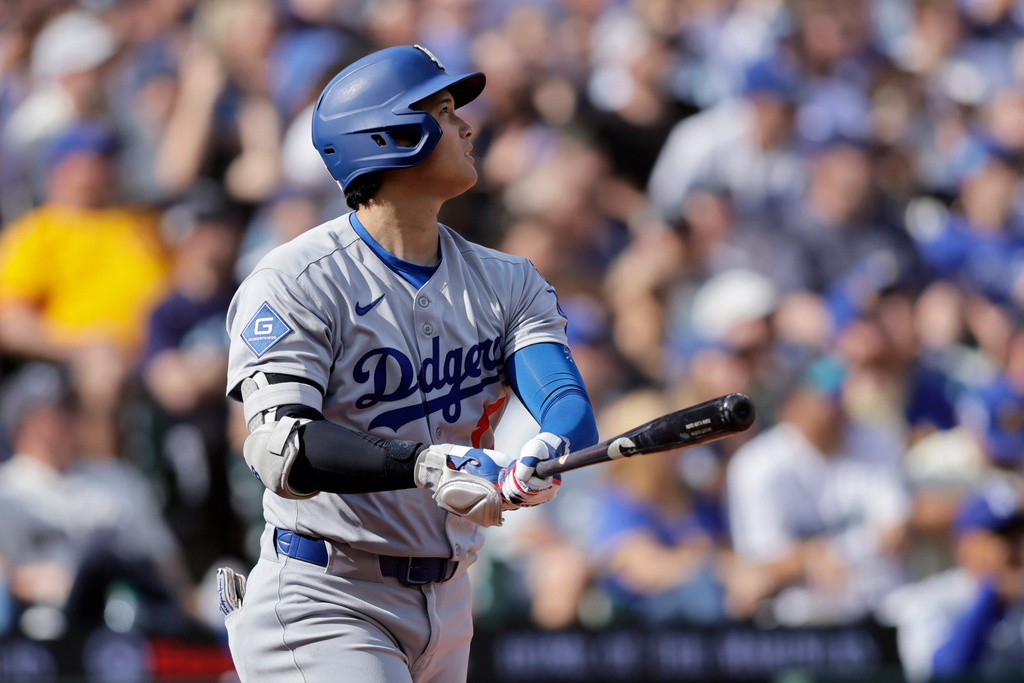 Los Angeles Dodgers' Shohei Ohtani watches his solo home run off Seattle Mariners pitcher Caleb Ferguson during the seventh inning of a baseball game Sunday, Sept. 28, 2025, in Seattle. (AP Photo/John Froschauer)