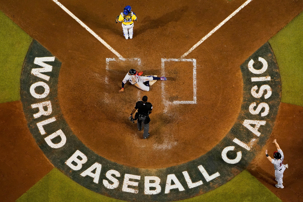 FILE - FILE - United States' Mookie Betts, center, scores against Colombia on Mike Trout's two-run single during the fifth inning of a World Baseball Classic game in Phoenix, Wednesday, March 15, 2023. (AP Photo/Godofredo A. Vásquez, File)