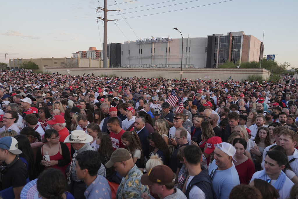 People wait in line before a memorial for conservative activist Charlie Kirk Sunday, Sept. 21, 2025, at State Farm Stadium in Glendale, Ariz. (AP Photo/Jae C. Hong)