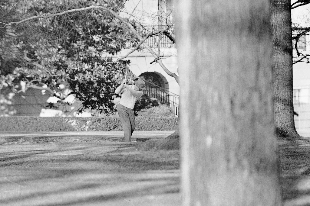 FILE - President Dwight Eisenhower brushes up on his golf game near the putting green on the lawn of the White House, Jan. 13, 1959, in Washington. (AP Photo, File)