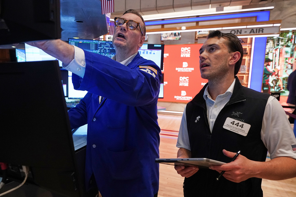 Specialist Patrick King, left, and trader Dylan Halvorsen work on the floor of the New York Stock Exchange, Thursday, June 25, 2026. (AP Photo/Richard Drew)