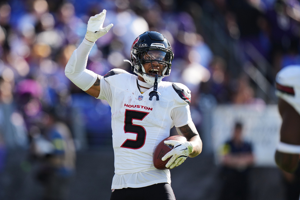 Houston Texans safety Jalen Pitre celebrates after an interception during the second half of an NFL football game against the Baltimore Ravens, Sunday, Oct. 5, 2025, in Baltimore. (AP Photo/Stephanie Scarbrough)