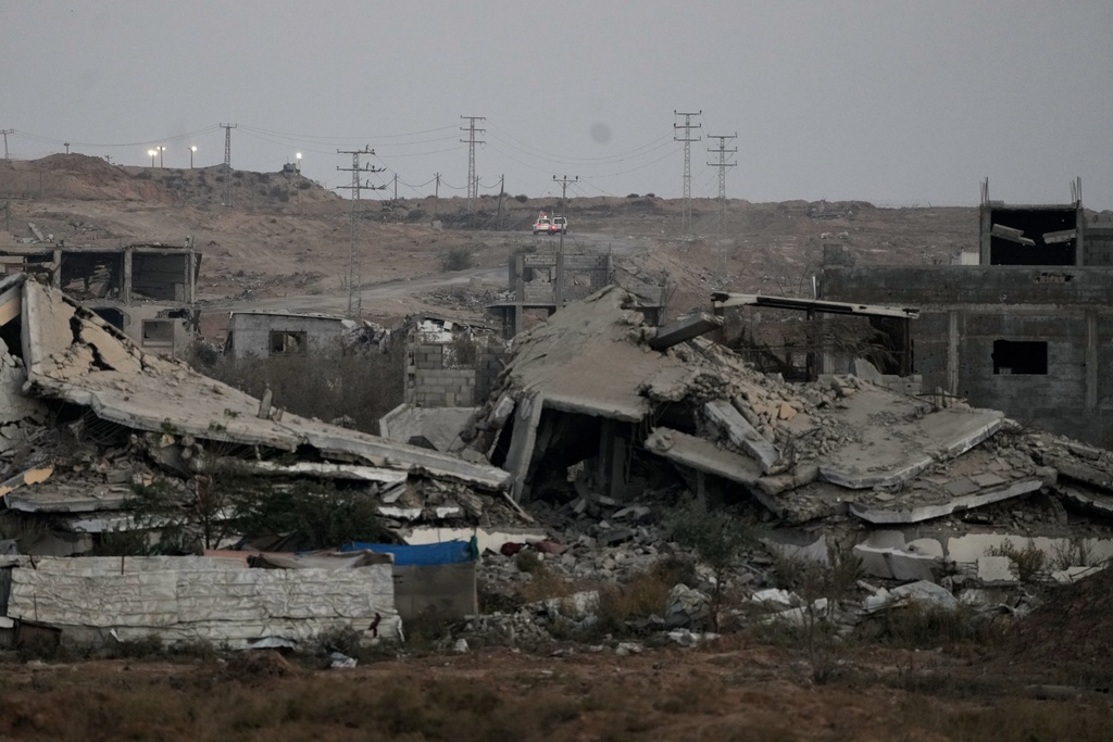 Red Cross vehicles carrying the bodies of two people believed to be deceased hostages handed over by Hamas make their way toward the Kissufim border crossing with Israel, to be transferred to Israeli authorities, in Deir al-Balah, central Gaza Strip, Thursday, Oct. 30, 2025. (AP Photo/Abdel Kareem Hana)