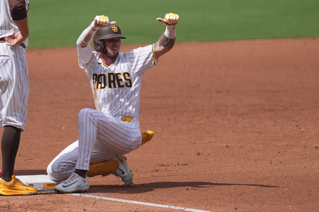 San Diego Padres' Jackson Merrill celebrates his two-RBI triple during the third inning of a baseball game against the Washington Nationals Wednesday, Sept. 9, 2026, in San Diego. (AP Photo/Gregory Bull)