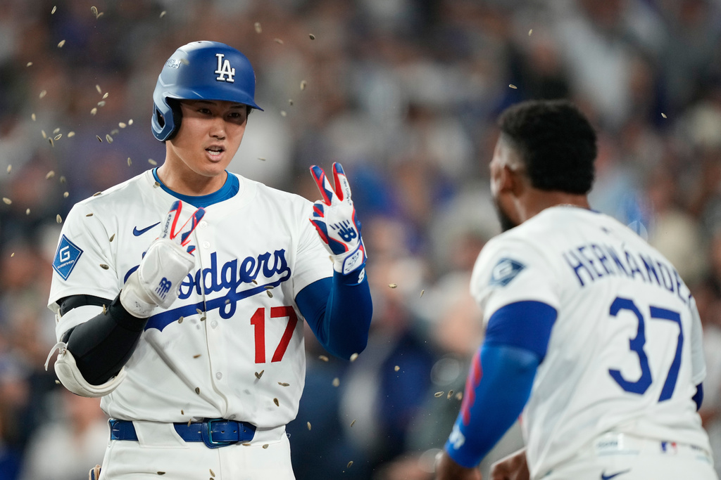 Los Angeles Dodgers' Shohei Ohtani celebrates with Teoscar Hernández (37) after his two-run home run during the sixth inning in Game 1 of the National League Wild Card baseball playoff series against the Cincinnati Reds, Tuesday, Sept. 30, 2025, in Los Angeles. (AP Photo/Mark J. Terrill)